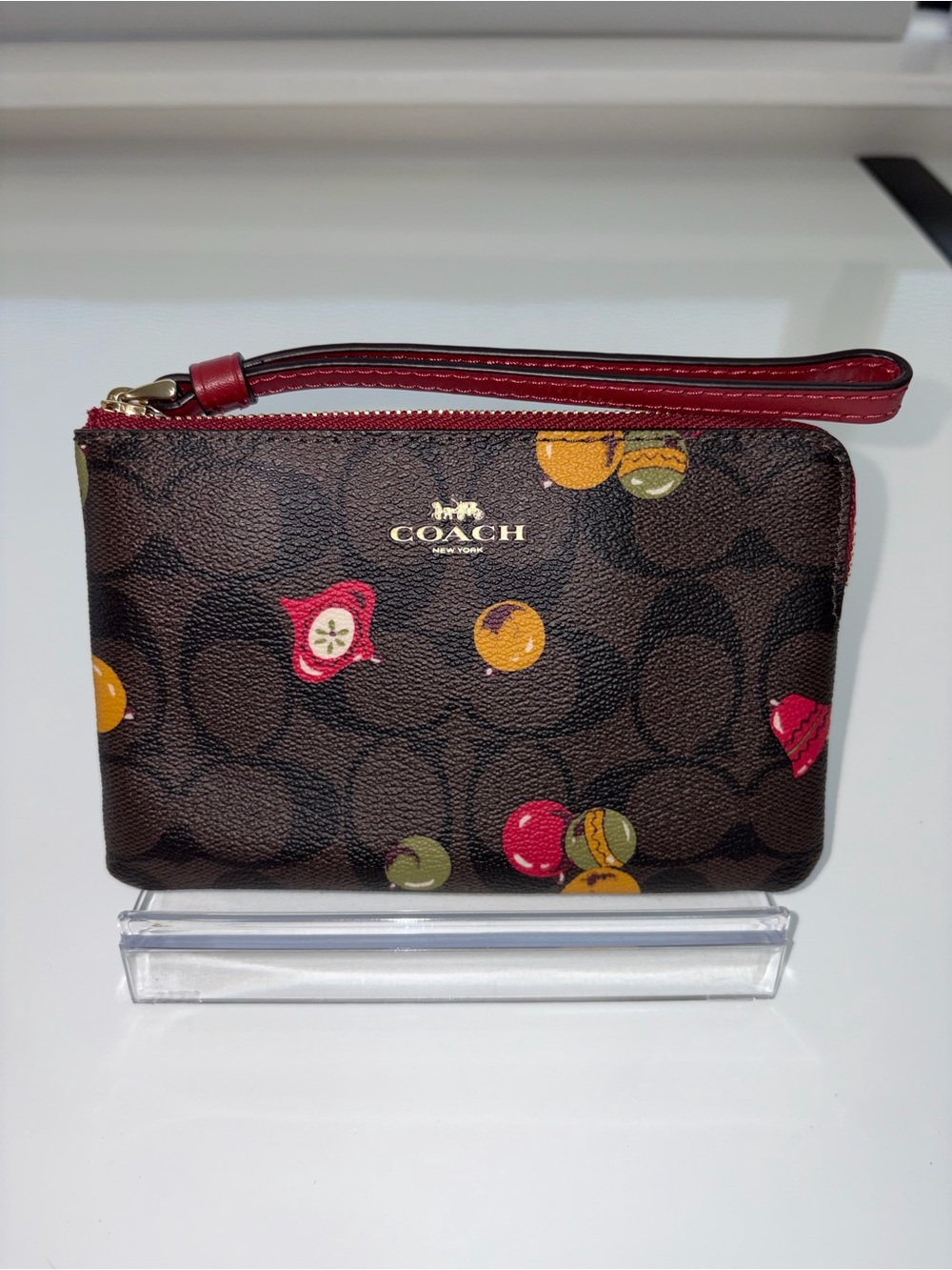 COACH Brown Signature Wristlet with Red Accent and Christmas Ornaments Print
